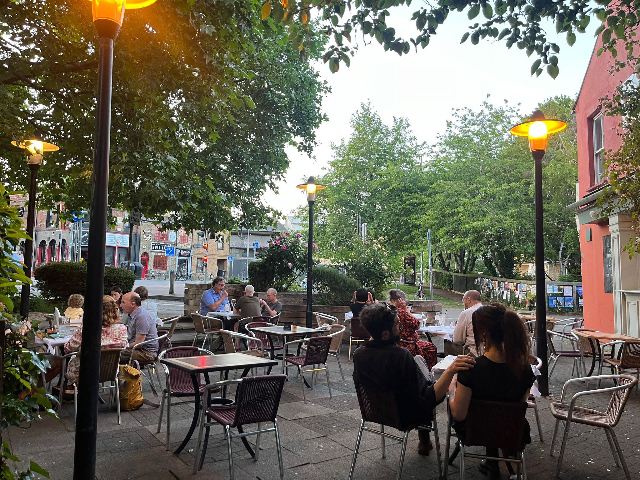 Guests dining on Soleá’s real terrace beneath the trees and outdoor lights